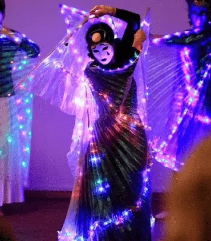 Sonnenschmidt Rhythmische Hormontherapie Clown Frau mit Lichterkette und Maske in tanzender Bewegung